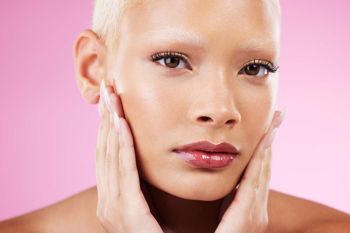 Portrait, beauty and natural with a model black woman in studio on a pink background for edgy cosme.