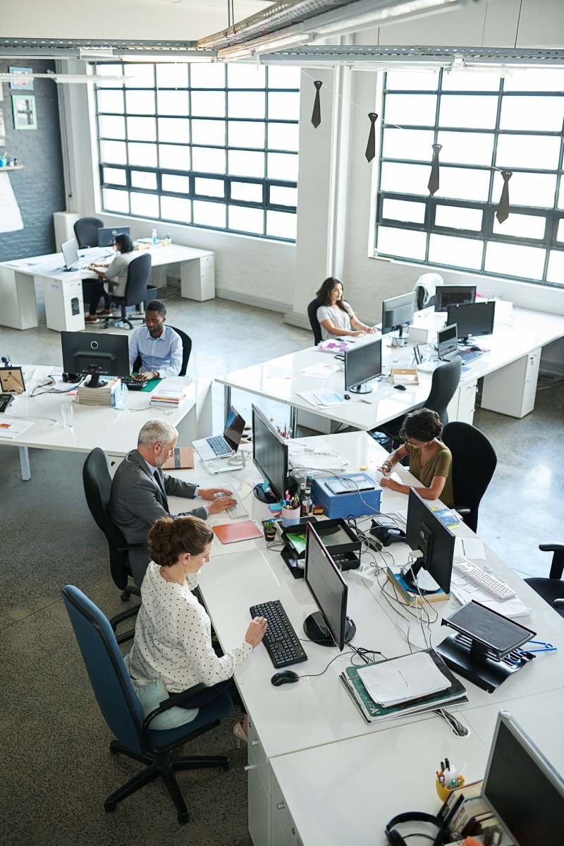 Shot of a group of coworkers sitting at their workstations in an office.