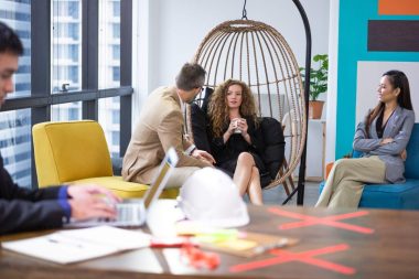 Group of diversity businesspeople discussing at couch in the office. man and woman enjoy talking at co-working space. brainstorming business, sharing story or small talk.