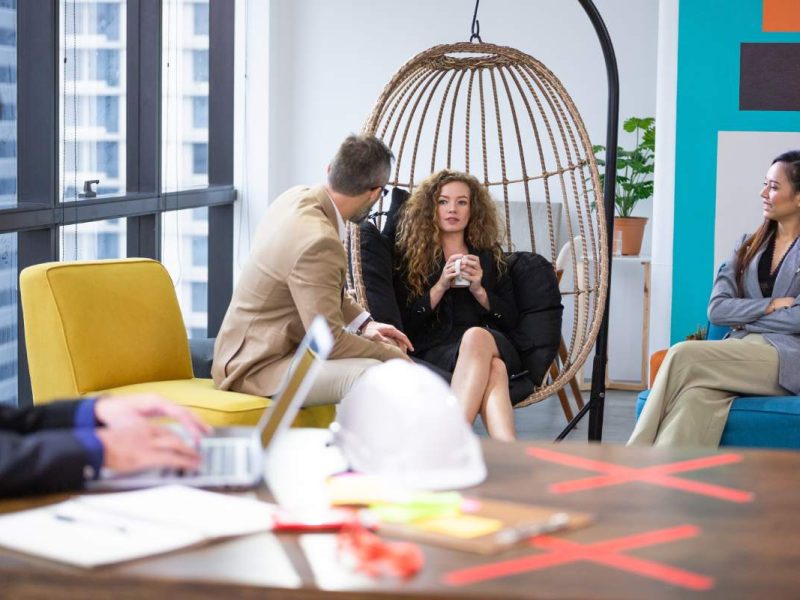 Group of diversity businesspeople discussing at couch in the office. man and woman enjoy talking at co-working space. brainstorming business, sharing story or small talk.