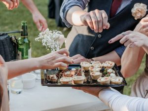 group-of-friends-eating-finger-food-at-a-wedding-r-2025-03-08-08-54-51-utc (1)