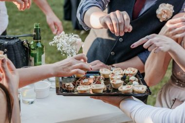 group-of-friends-eating-finger-food-at-a-wedding-r-2025-03-08-08-54-51-utc (1)